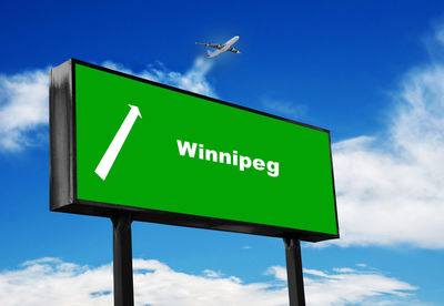 Low angle view of road sign against sky