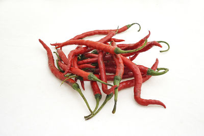 Close-up of red chili over white background