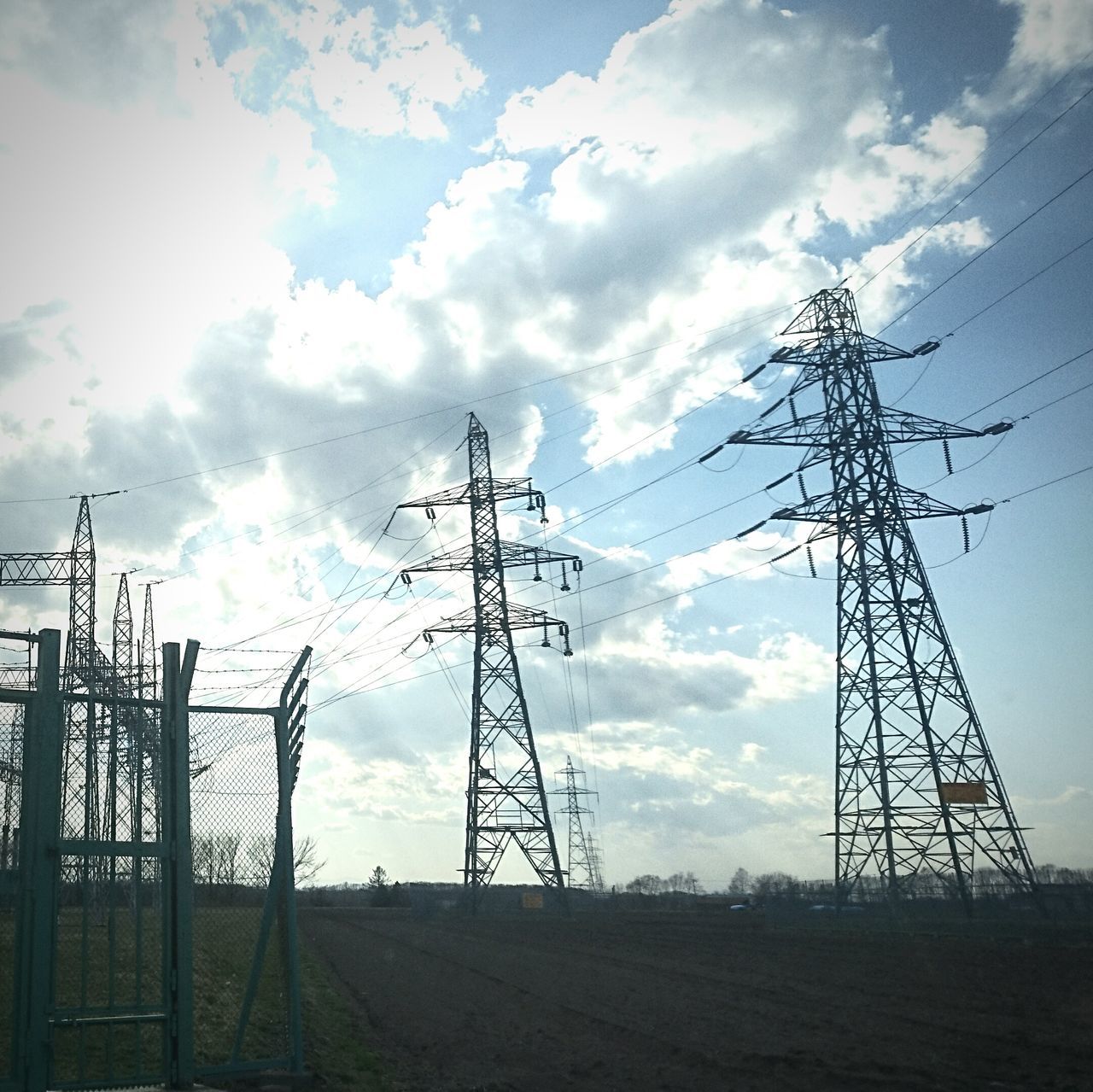 sky, electricity pylon, cloud - sky, fuel and power generation, low angle view, electricity, cloudy, power supply, power line, cloud, technology, field, connection, fence, silhouette, nature, outdoors, no people, landscape, day