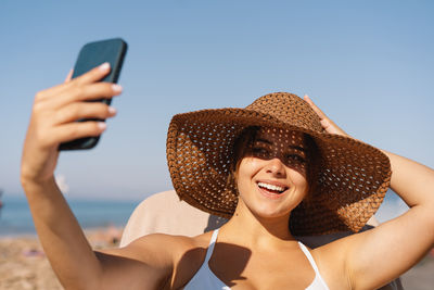 Young woman using mobile phone at beach