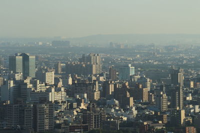 Aerial view of modern buildings in city against sky