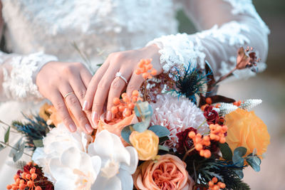 Midsection of woman holding bouquet