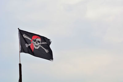 Low angle view of flag against sky