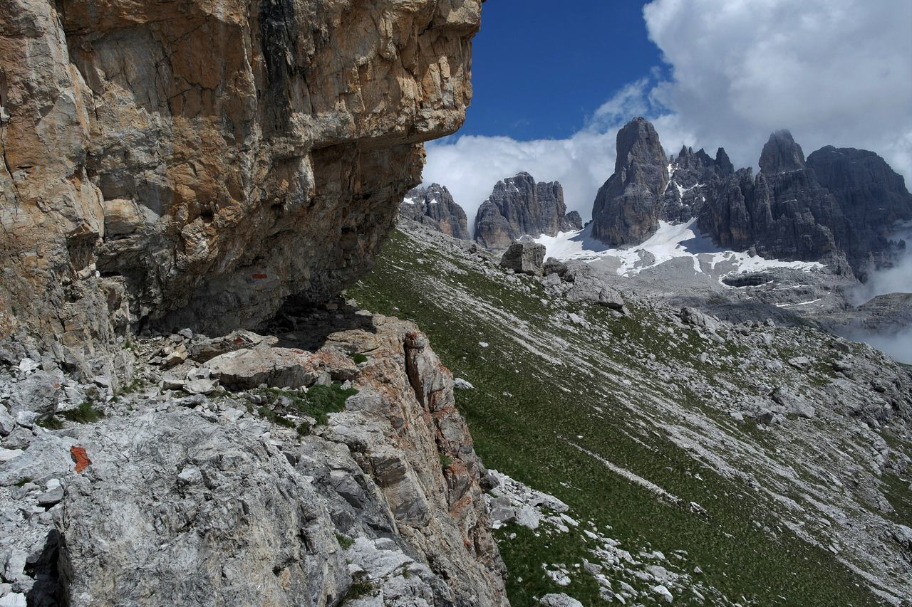 mountain, rock formation, rock - object, sky, rocky mountains, tranquility, tranquil scene, scenics, beauty in nature, nature, rough, geology, cliff, physical geography, landscape, rock, non-urban scene, rocky, cloud - sky, low angle view