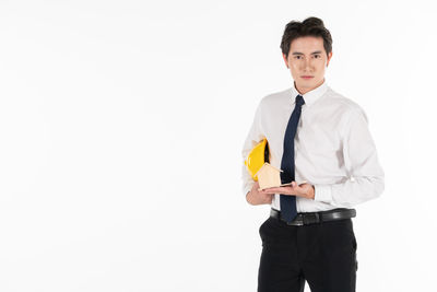 Young man standing against white background