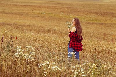 Full length of woman standing on field