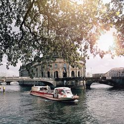 Boats in river with buildings in background