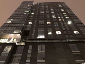 Low angle view of modern building against sky at night