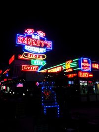 Low angle view of illuminated sign at night