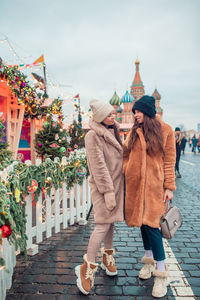 People at town square against sky during winter