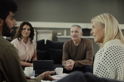 Group of business people having meeting in lobby