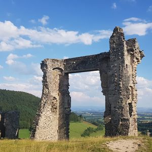 Old ruin on field against sky