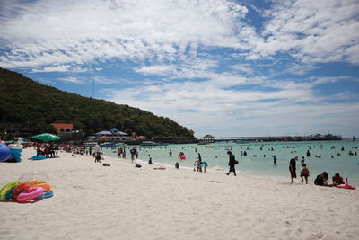 People on beach against sky