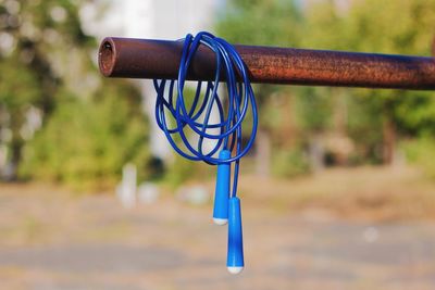 Blue jump rope hanging on the horizontal bar