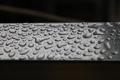 Close-up of raindrops on table