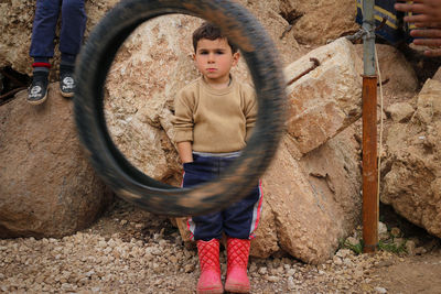 Portrait of boy standing outdoors