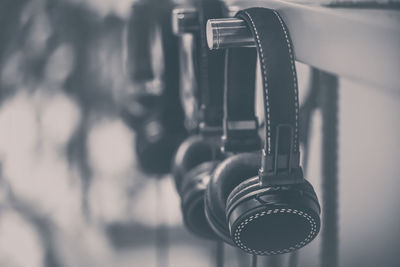 Close-up of headphones hanging on metal