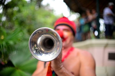 Close-up of man playing trumpet outdoors