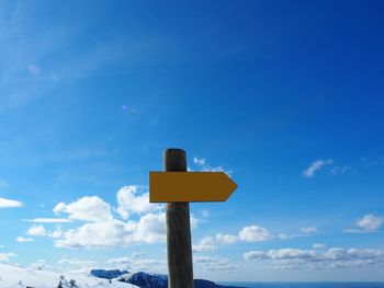 Low angle view of road sign against sky