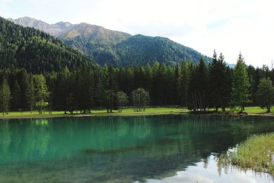 Scenic view of lake and mountains against sky