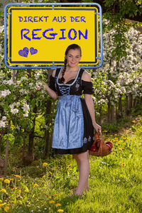 Woman standing with text against plants