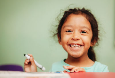 Portrait of cute girl studying at home