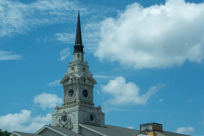 Low angle view of tower of building against cloudy sky