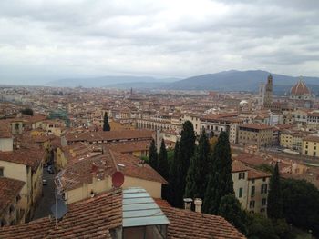 High angle shot of townscape against cloudy sky