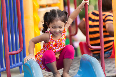 Cute girl sitting at playground