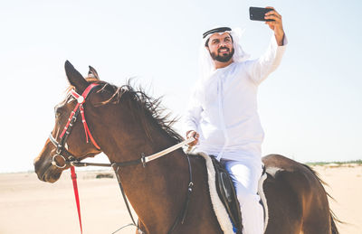 Young man riding horse