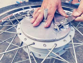 High angle view of man working on bicycle