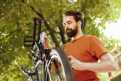 Portrait of young man riding bicycle