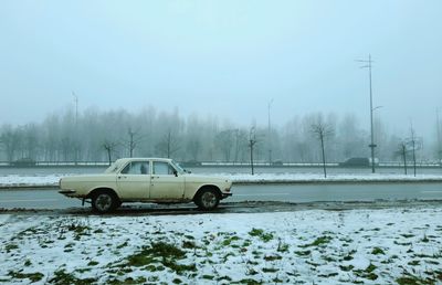 White retro car on road in winter