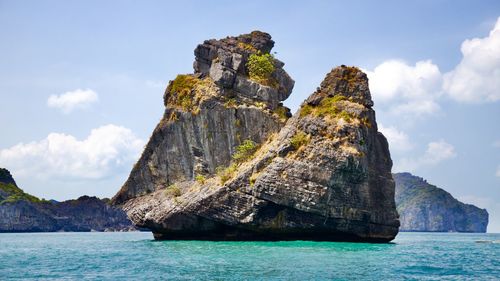 Rock formations in sea against sky