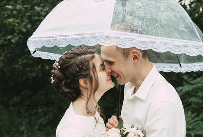 Close-up of couple with umbrella