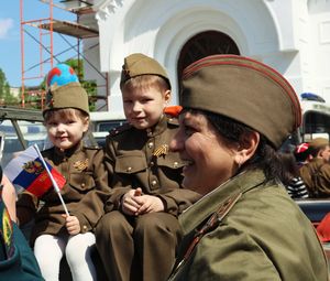 Boy and smiling while standing against built structure