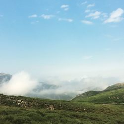 Scenic view of mountains against cloudy sky