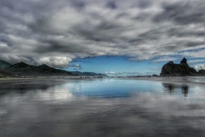Scenic view of sea against cloudy sky