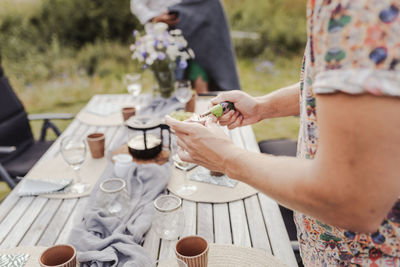 Man preparing table for garden party