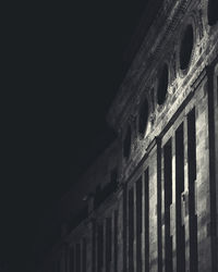 Low angle view of illuminated building against sky at night