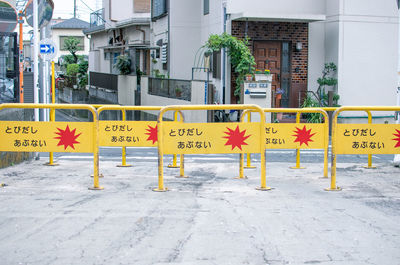 Information sign on street against buildings in city