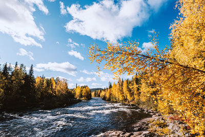 Scenic view of waterfall against sky during autumn