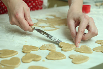 Cropped image of woman preparing cookies at table