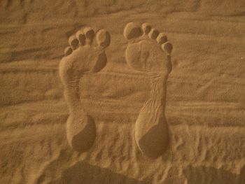 Close-up of footprints on sand