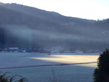 Scenic view of landscape against sky during winter