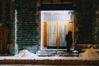 Reflection of woman in front of building