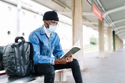 Man using mobile phone while sitting in bus