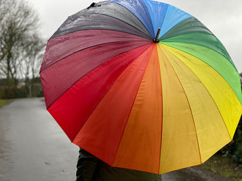 Close-up of wet umbrella against sky during rainy season