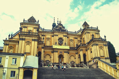 Low angle view of historical building against cloudy sky