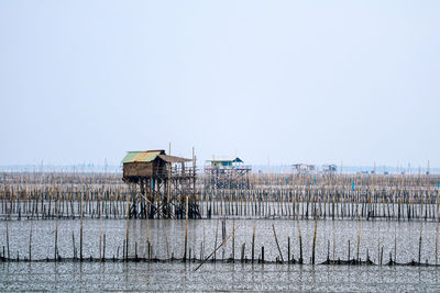 Scenic view of lake by house against clear sky